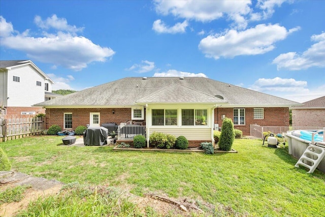 rear view of property featuring a yard