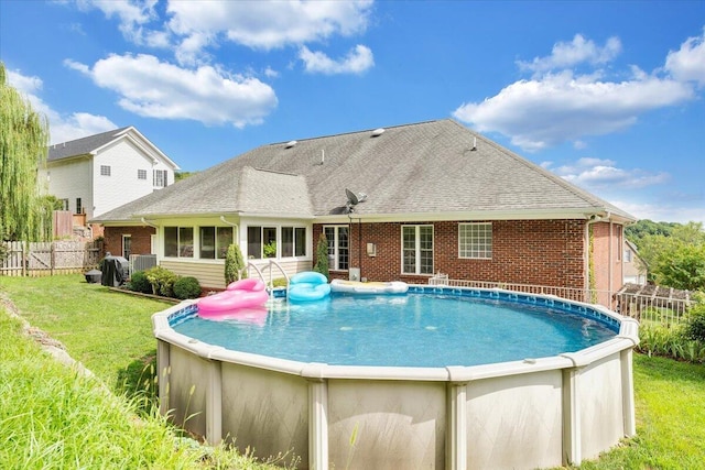 view of pool with a lawn