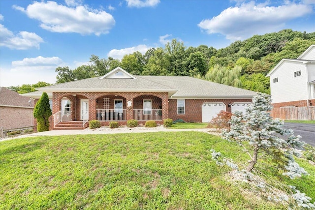 single story home featuring covered porch, a front yard, and a garage