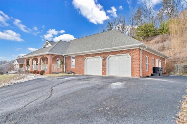 view of front of house featuring covered porch and a garage