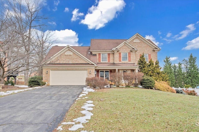 view of front of house featuring a garage and a front yard