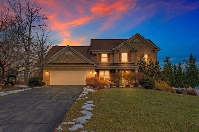 view of front of property with a lawn and a garage