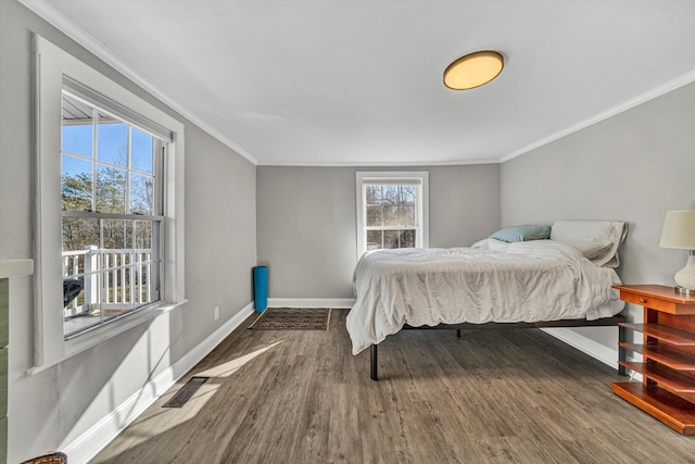 bedroom with ornamental molding and dark wood-type flooring