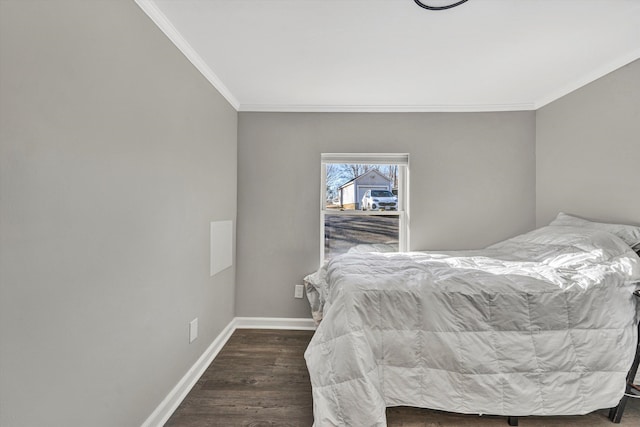 bedroom with dark hardwood / wood-style flooring and crown molding