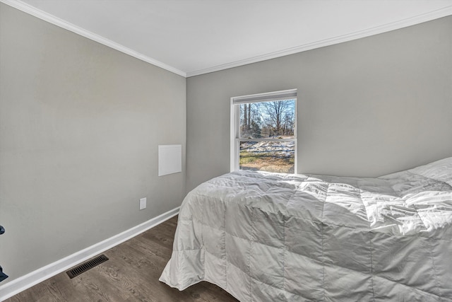 bedroom featuring ornamental molding and dark hardwood / wood-style floors