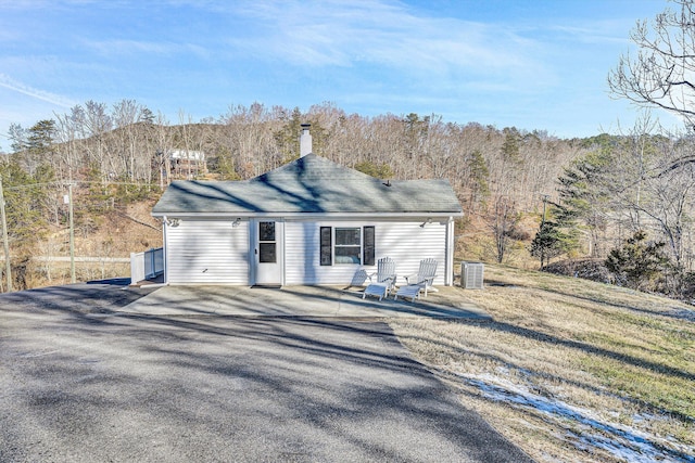 back of property featuring central AC