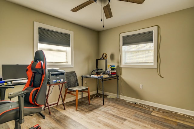 office area with light wood-type flooring, plenty of natural light, and ceiling fan