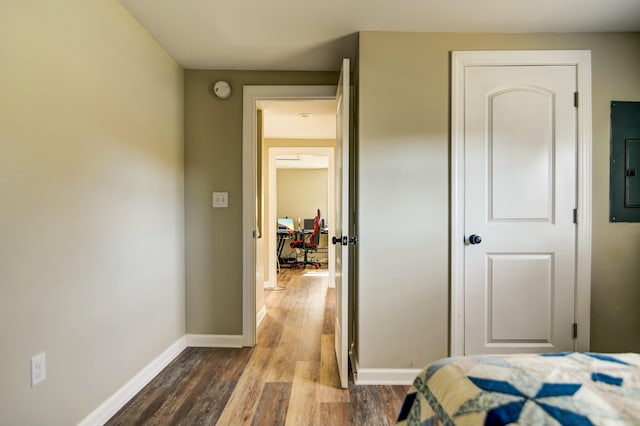 bedroom featuring electric panel and hardwood / wood-style floors