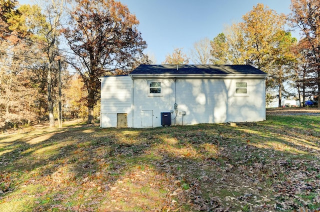 view of outbuilding featuring a yard and central AC unit