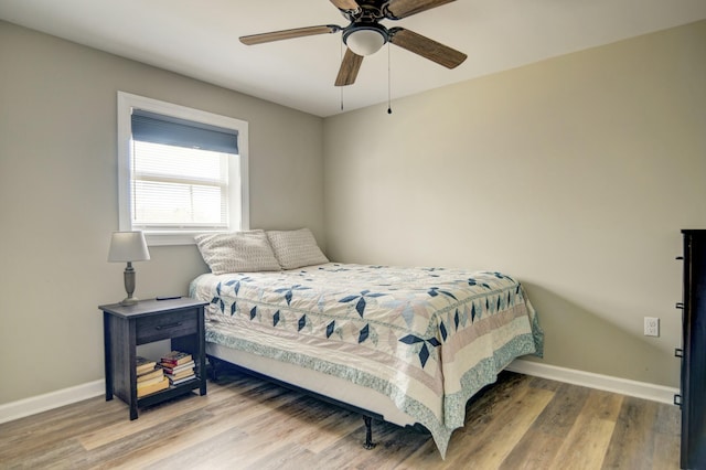 bedroom with hardwood / wood-style floors and ceiling fan