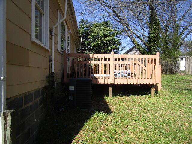 view of yard with a wooden deck and central AC unit