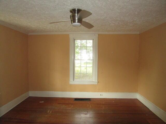 spare room featuring a textured ceiling, dark hardwood / wood-style flooring, ceiling fan, and ornamental molding