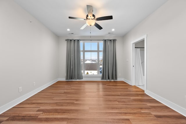 empty room with light wood-type flooring and ceiling fan