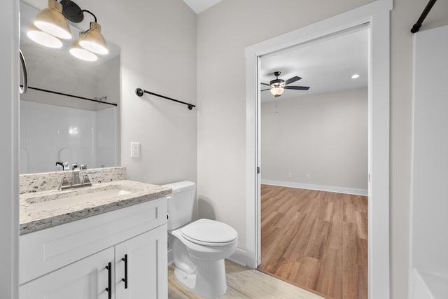 bathroom featuring hardwood / wood-style floors, vanity, a shower, ceiling fan, and toilet