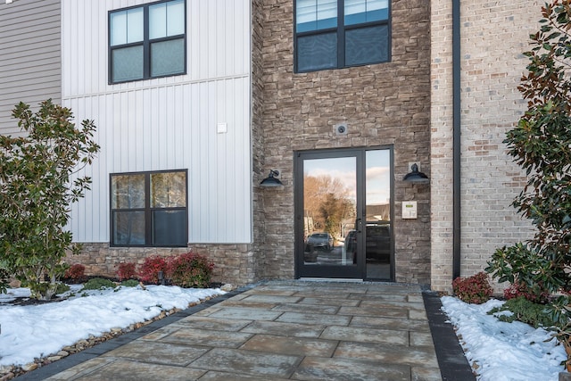 view of snow covered property entrance