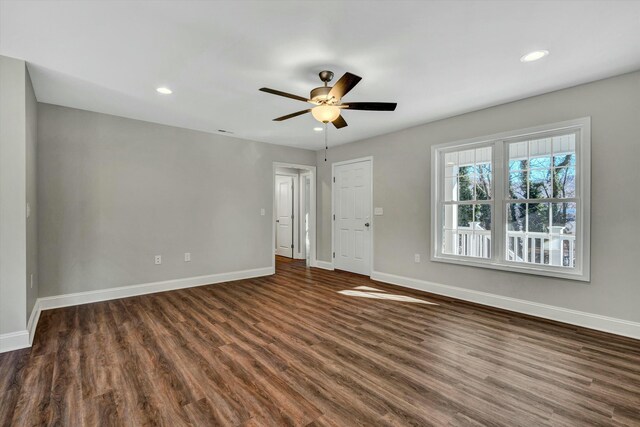 spare room with ceiling fan and dark hardwood / wood-style floors