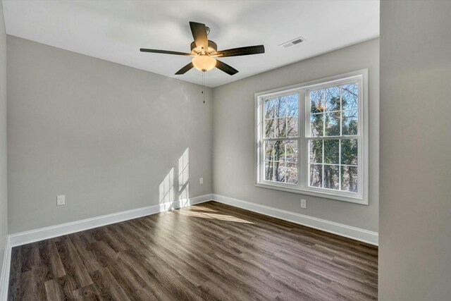 unfurnished bedroom featuring ceiling fan, dark hardwood / wood-style flooring, and a closet