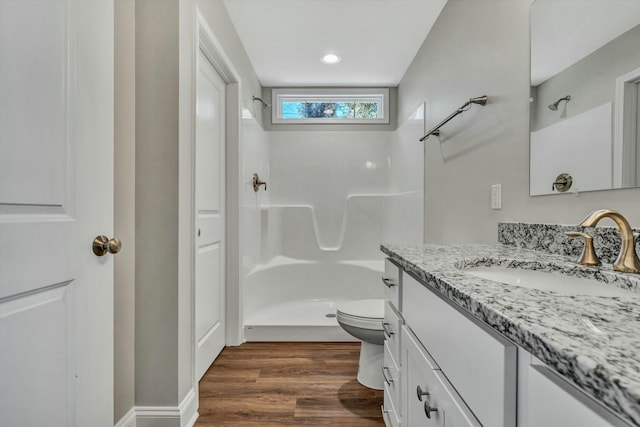 bathroom with toilet, walk in shower, wood-type flooring, and vanity