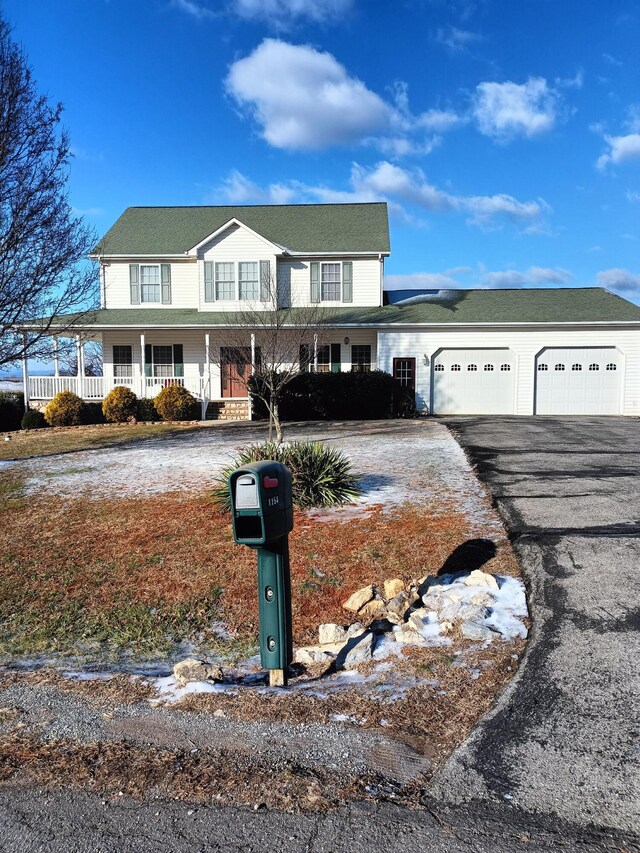 view of front of property with covered porch and a garage