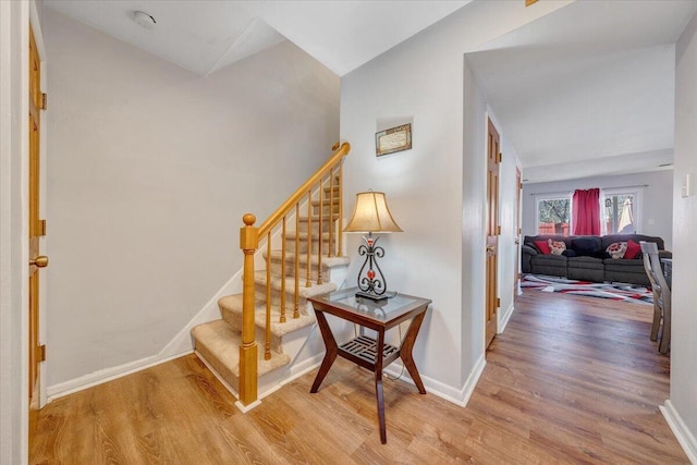 interior space with hardwood / wood-style floors and lofted ceiling