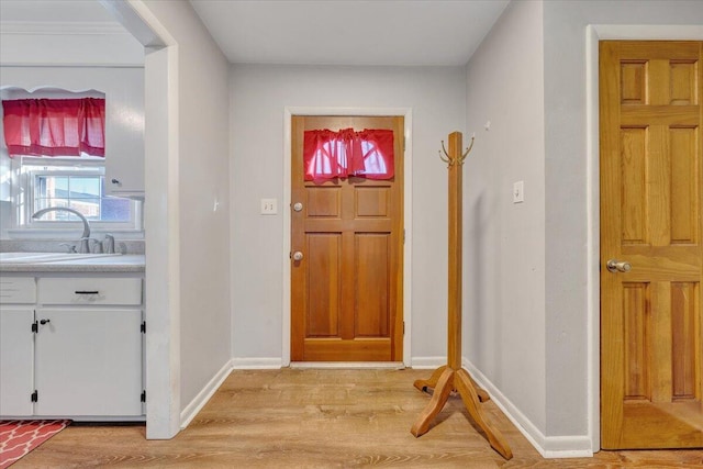 entrance foyer with light hardwood / wood-style floors and sink