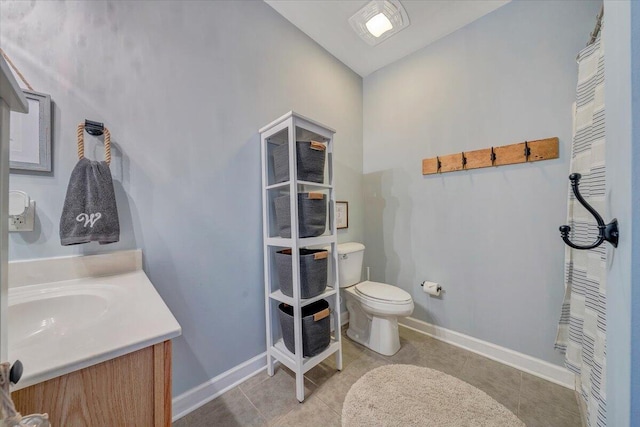 bathroom featuring toilet, vanity, and tile patterned floors