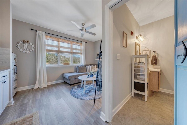 living area with ceiling fan and light hardwood / wood-style floors