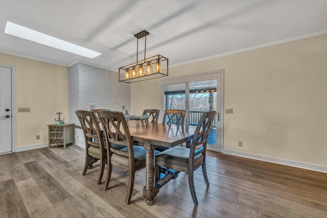 dining area with crown molding, a skylight, a textured ceiling, and wood-type flooring