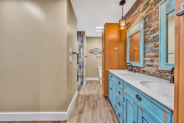 bathroom featuring vanity, wood-type flooring, and toilet