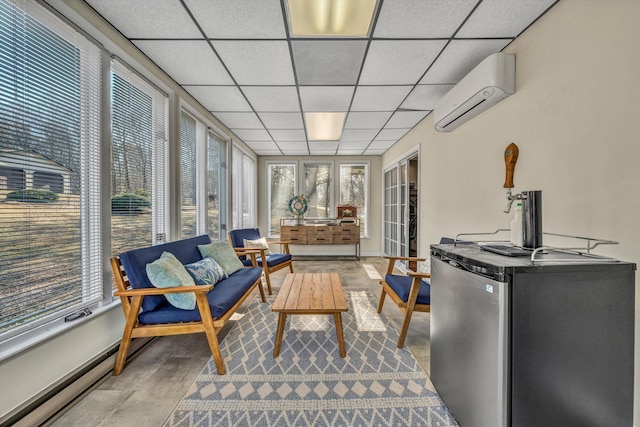 sunroom / solarium featuring a drop ceiling and an AC wall unit