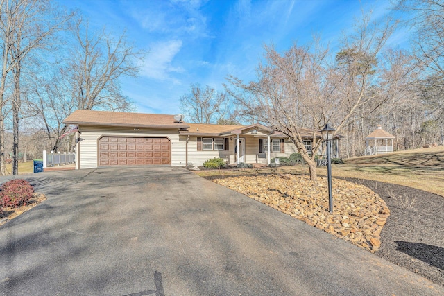 ranch-style house with a gazebo and a garage