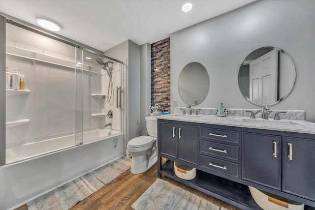 full bathroom featuring vanity, wood-type flooring, enclosed tub / shower combo, and toilet