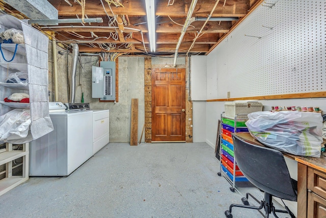 basement featuring separate washer and dryer and electric panel