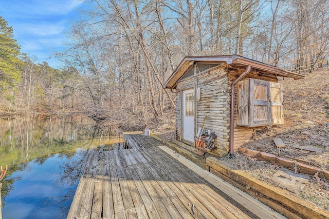 exterior space featuring a water view and an outbuilding