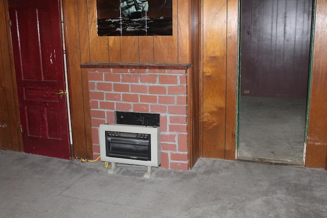 details with a fireplace, wooden walls, carpet, and heating unit