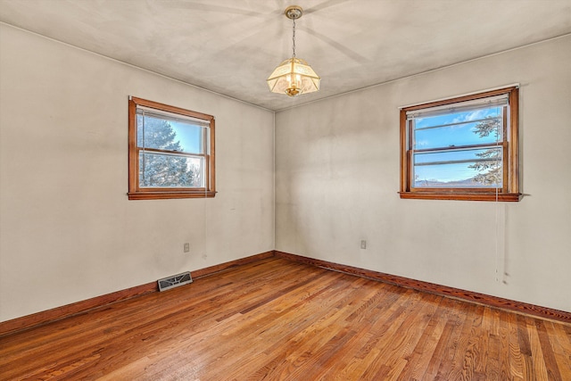 unfurnished room featuring hardwood / wood-style flooring