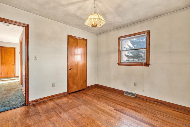 empty room featuring wood-type flooring