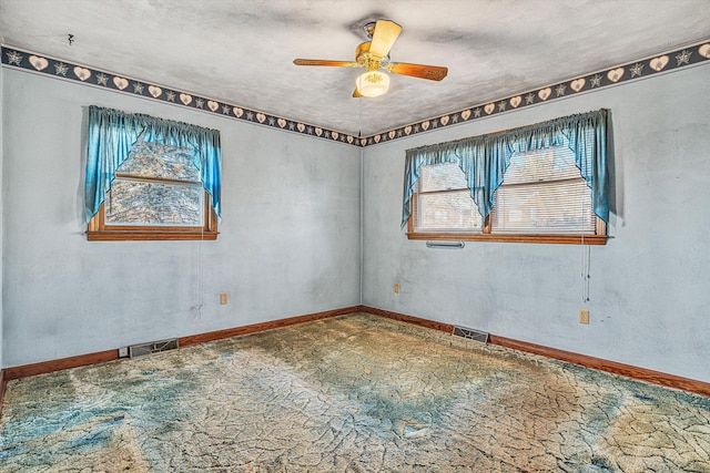 carpeted empty room featuring ceiling fan