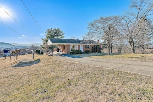 ranch-style house with a mountain view, a front yard, and a carport