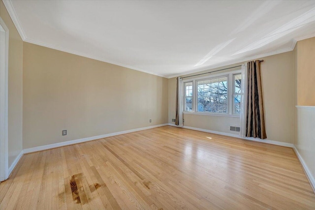 unfurnished room featuring ornamental molding and light wood-type flooring