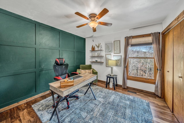 home office featuring ceiling fan and dark hardwood / wood-style flooring