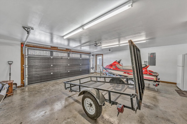 garage featuring electric panel, white fridge, and a garage door opener