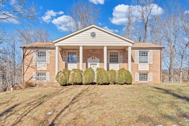 view of front of property featuring covered porch and a front yard