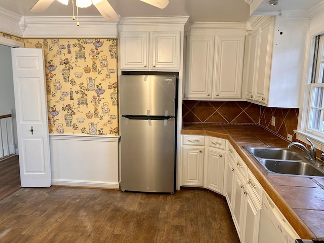 kitchen featuring white dishwasher, white cabinets, ceiling fan, and stainless steel range with electric cooktop