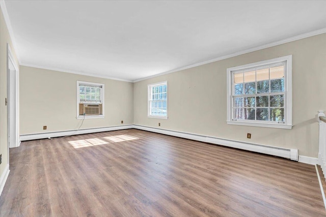 empty room with baseboard heating, light hardwood / wood-style flooring, and ornamental molding