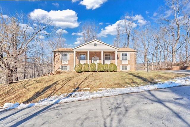 view of front of home with a porch and a yard