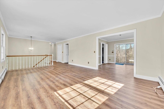 empty room featuring ornamental molding, light hardwood / wood-style floors, and an inviting chandelier