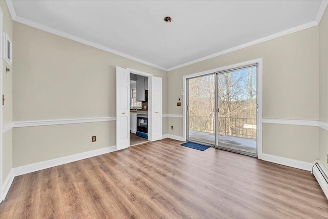 unfurnished living room with light hardwood / wood-style flooring, baseboard heating, and crown molding