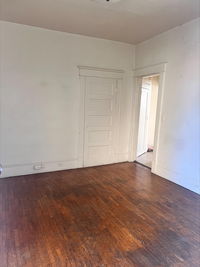 unfurnished room featuring dark hardwood / wood-style flooring