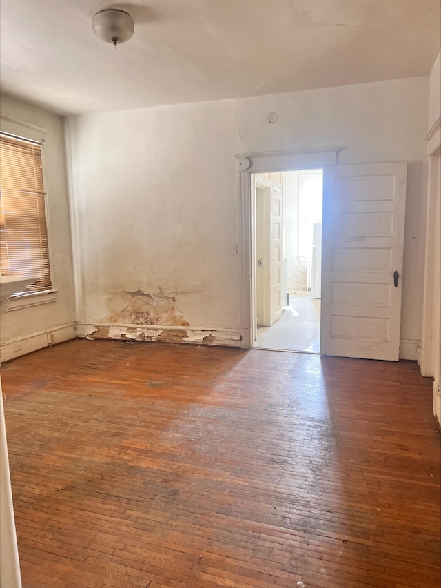 unfurnished room with hardwood / wood-style flooring